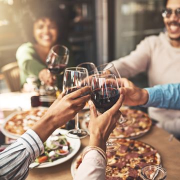 friends with wine and pizza