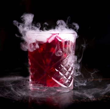 halloween cocktail with dry ice on dark background